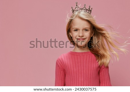 Happy Princess Girl in Pink Dress with Crown Celebrating Birthday Party In this joyful image, a cute blonde girl wearing a pink dress and a crown is celebrating her birthday party She is surrounded by