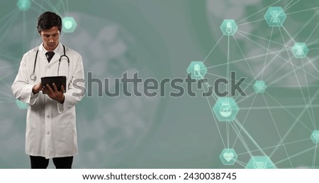 Caucasian male doctor using digital tablet against globes of medical icons spinning. medical research and technology concept