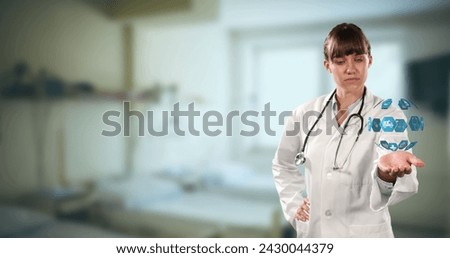 Globe of medical icons spinner over hand of caucasian female doctor against hospital in background. medical research and technology concept