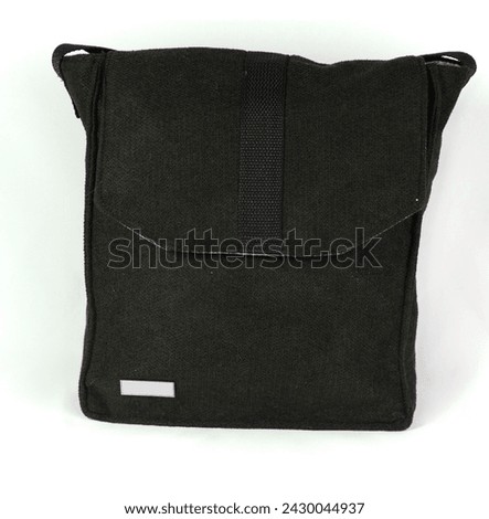Black wool cotton backpack. Bag to hang on the shoulder, on the side of the body. Large clutch with black straps to adjust its size. Large storage bag, unisex haversack isolated on white background Royalty-Free Stock Photo #2430044937