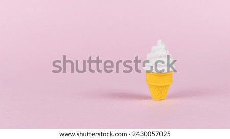 A cup of creamy ice cream on a pink background. Summer concept.