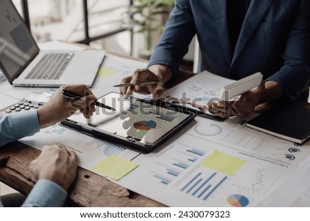 Business people meeting in a business presentation or seminar, documents, graphs and financial or marketing charts are There is a laptop and digital tablet on the table. Close-up shot