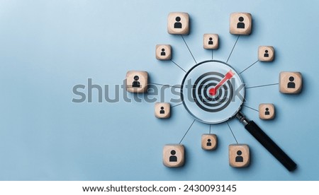 Goal concepts in customer relationship management Magnifying glass with target icon and wooden block linked to human icon for customer focus group. Leadership development planning. copy space