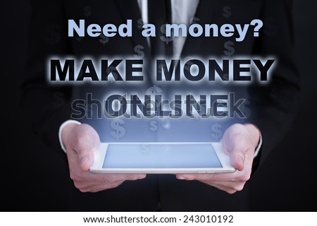 businessman holding a tablet PC with the make money button. business concept. Internet concept. Make Money Online
