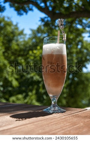Smoothie or cold coffee on a green background.Template for advertising your product. Vertical photo