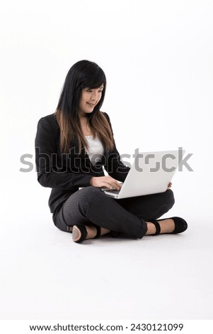 Portrait of a stylish Chinese Businesswoman using a laptop. Isolated on white background. Asian brunette female model.