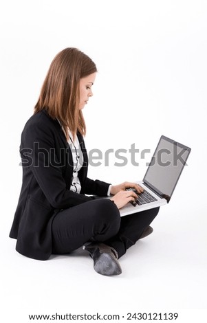Portrait of a stylish Businesswoman using a laptop. Isolated on white background. Caucasian brunette female model.