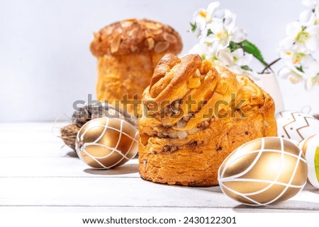 Easter background with baking cruffin pandoro pannetone cake, with colorful painted Easter eggs. Happy Easter greeting card background