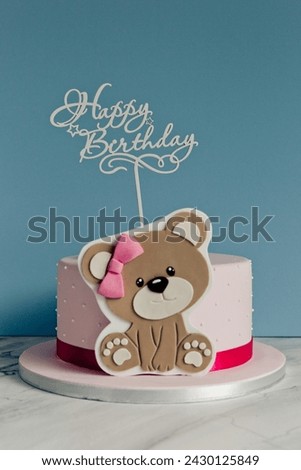 Teddy bear birthday cake on a blue background with text Happy Birthday