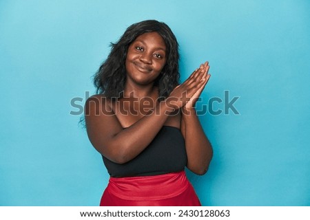 Young african american curvy woman feeling energetic and comfortable, rubbing hands confident.