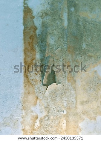 The texture of damaged and peeling walls is white to brown due to seeping water or moisture Royalty-Free Stock Photo #2430135371