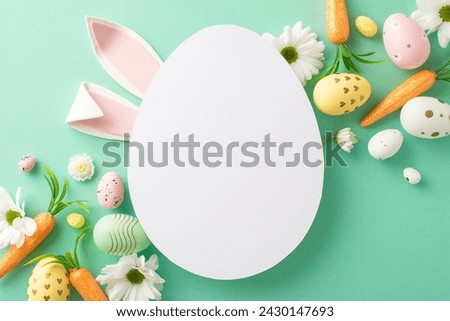 Easter art concept: top view photo of multicolored eggs, lovely bunny ears, treats for Easter Bunny like carrots, chamomile blooms on turquoise surface, with open egg-shaped area for wording or promo