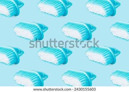 A large group of cleaning brushes on a blue plain background. Pattern. Royalty-Free Stock Photo #2430155603