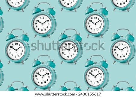 Large group of alarm clocks in retro style on a plain background. Pattern. Low angle view. Royalty-Free Stock Photo #2430155617