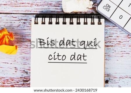 Bis dat qui cito dat It is translated from Latin as The one who gives twice is the one who gives quickly It is written on the notebook in close-up