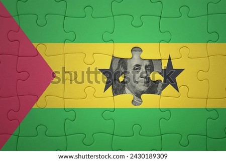 puzzle with the colourful national flag of sao tome and principe and usa dollar banknote. finance concept