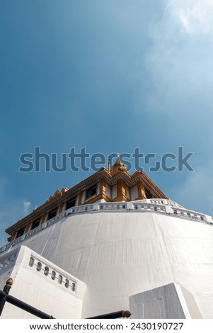 View of the Golden Temple in Bangkok, Thailand. The white temple stands out beautifully against the blue sky in the background. The picture was taken in January 2024.