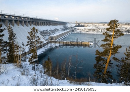 Bratsk hydroelectric power station, Bratsk city, Irkutsk region, Siberia, Russia. Large hydroelectric power station on the Angara River. View of the dam and the hydroelectric power station building. Royalty-Free Stock Photo #2430196035