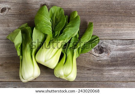 Overhead shot of Chinese cabbage, Bok Choy, on rustic wood Royalty-Free Stock Photo #243020068