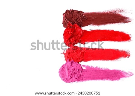 Different multi colored samples of a smudged lipstick over white background