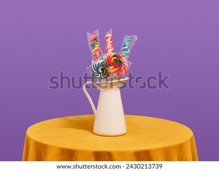 Delicious bright colored lollipops stand in a white pitcher. Image of cheerful holiday.