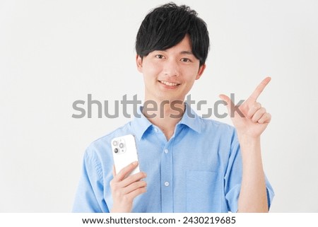 Asian man with the smartphone check mark gesture in white background