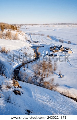 Beautiful winter landscape from a bird's eye view, non-freezing lake in winter, karst spring, outdoor recreation center. High quality photo