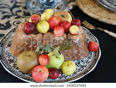 Meal of meat pie and red fruit served on a plate on the table                               