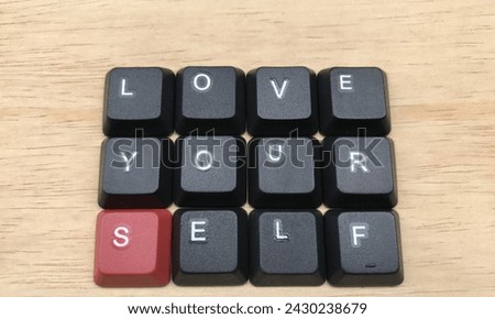 Love yourself word on black keyboard button on wood background, Love yourself concept