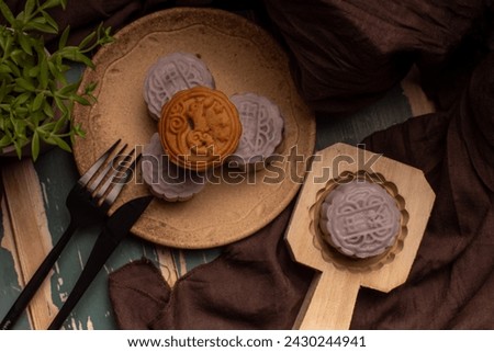 Chinese cakes are on the gray cloth of the wooden table