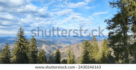 Magnificent cumulus, cirrus and stratus clouds in the sky over a mountainous area before sunset. The last month of winter. Transparent air. The fascinating landscape of the Ukrainian Carpathians