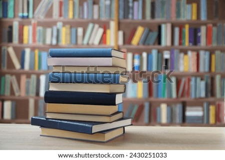 stack of books on wooden table in library, education