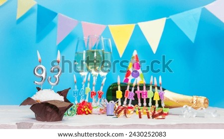 Date of birth with candles and number  93. Anniversary greeting card. Holiday decorations. Happy birthday candles. Multicolored decorations with garland Royalty-Free Stock Photo #2430252083