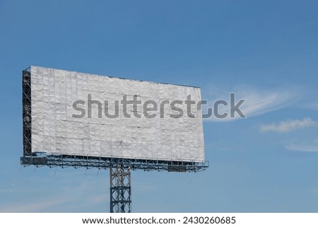 White billboard with blue sky and clouds background