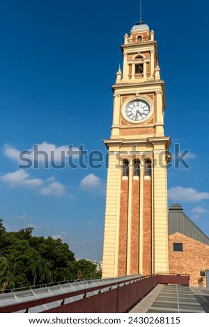 The traditional clock in the Luz station tower, on the terrace of the building that houses the Portuguese language museum, in the city of São Paulo Royalty-Free Stock Photo #2430268115