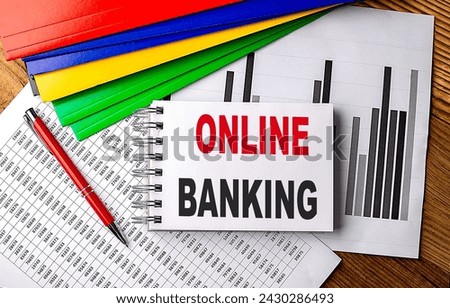 ONLINE BANKING text on a notebook with pen, folder on a chart background