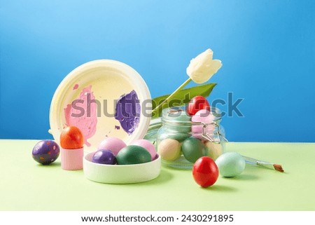 Easter poster and banner template with Easter eggs in minimal colors displayed with a paintbrush, a branch of flower and a dish of paint color. Easter Day a Christian holy day in March or April