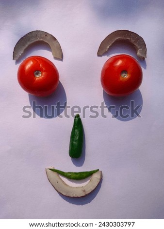 Human Face created using tomatoes green chillies and dried coconut pieces simple installation art work ultrahd hi-res jpg stock image photo picture selective focus vertical background top ankle view 