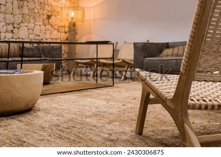 Close-up view of a rustic design chair in an empty hotel room waiting for tourists to return. Tourism concept Royalty-Free Stock Photo #2430306875