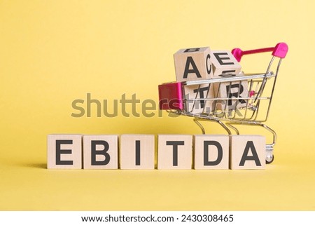 The word ebitda is written on a wooden cubes structure. Can be used for business, education, financial concept. selective focus