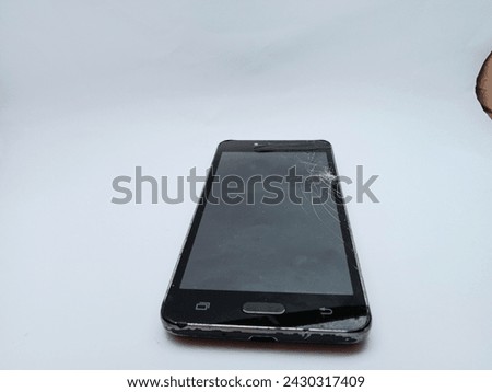 Isolated black smart phone with cracked screen on white background