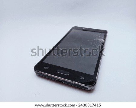Isolated black smart phone with cracked screen on white background