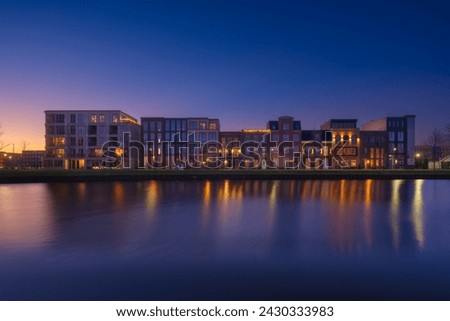 A cityscape during sunset. A apartment building near the water in the bay. Architecture. Travel photography.