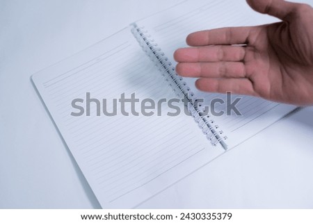 close-up of hand pointing palm at book, advertisement, copy space, isolated on white background