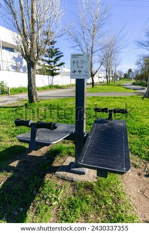 Outdoor abdominal machine in urban park, promoting an active and healthy lifestyle. Perfect for fitness and wellness-related stock photography projects.