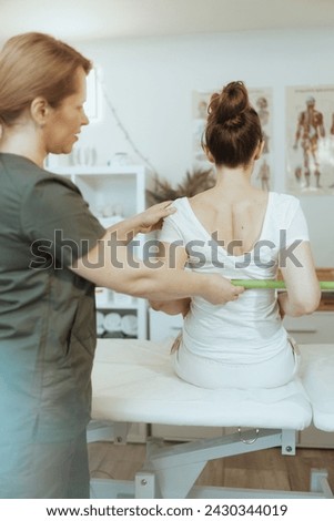 Healthcare time. pensive massage therapist woman in massage cabinet with client doing checkup.