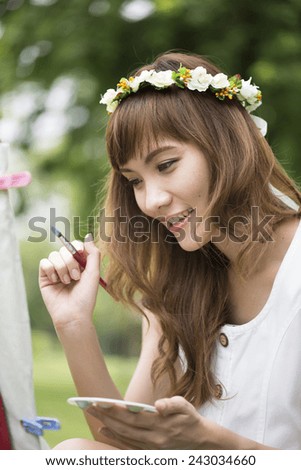 beautiful young woman drinking water in a park