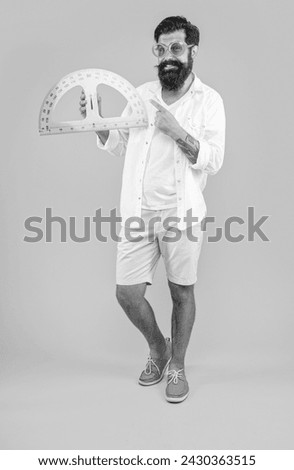 man hold geometry protractor on background, point finger. photo of man hold geometry protractor.