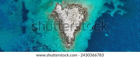 Aerial drone ultra wide photo of secluded heart shaped island with turquoise sea in Caribbean exotic destination