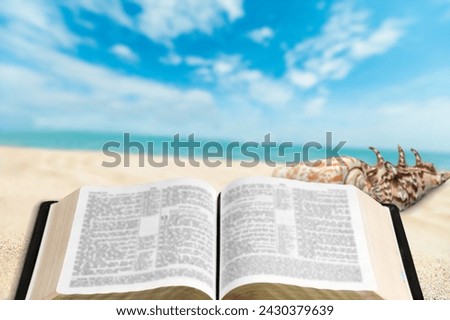 Holy Bible book sandy beach
